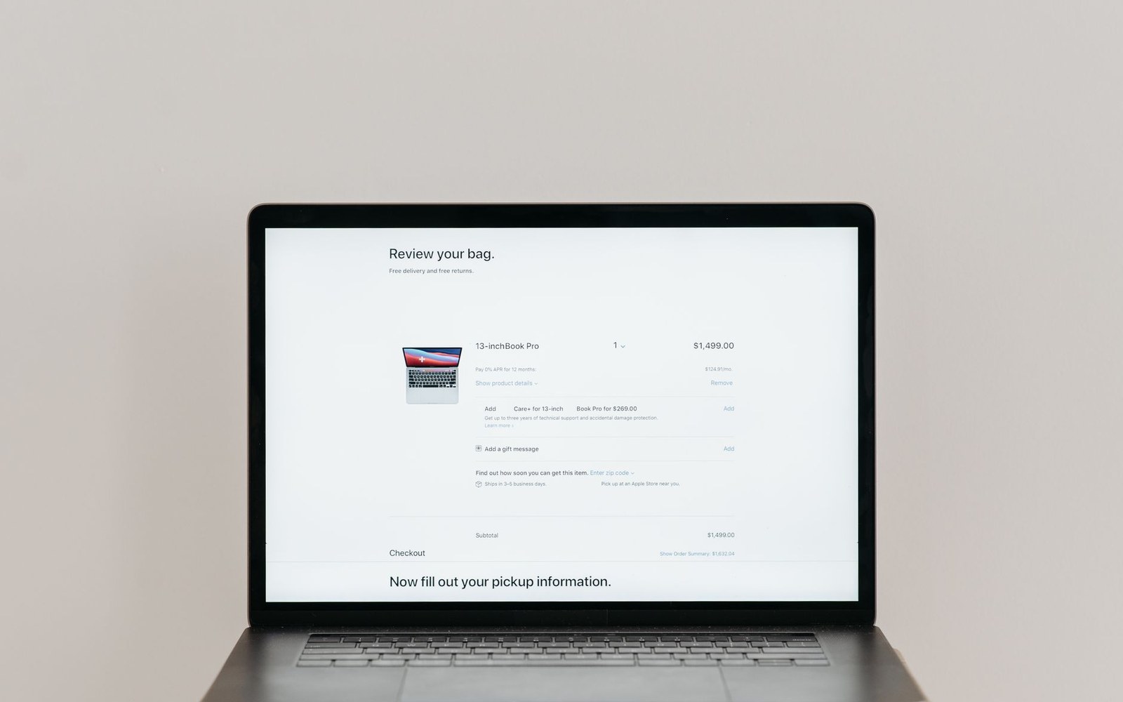 Laptop screen showing an online shopping cart with a laptop purchase ready for checkout
