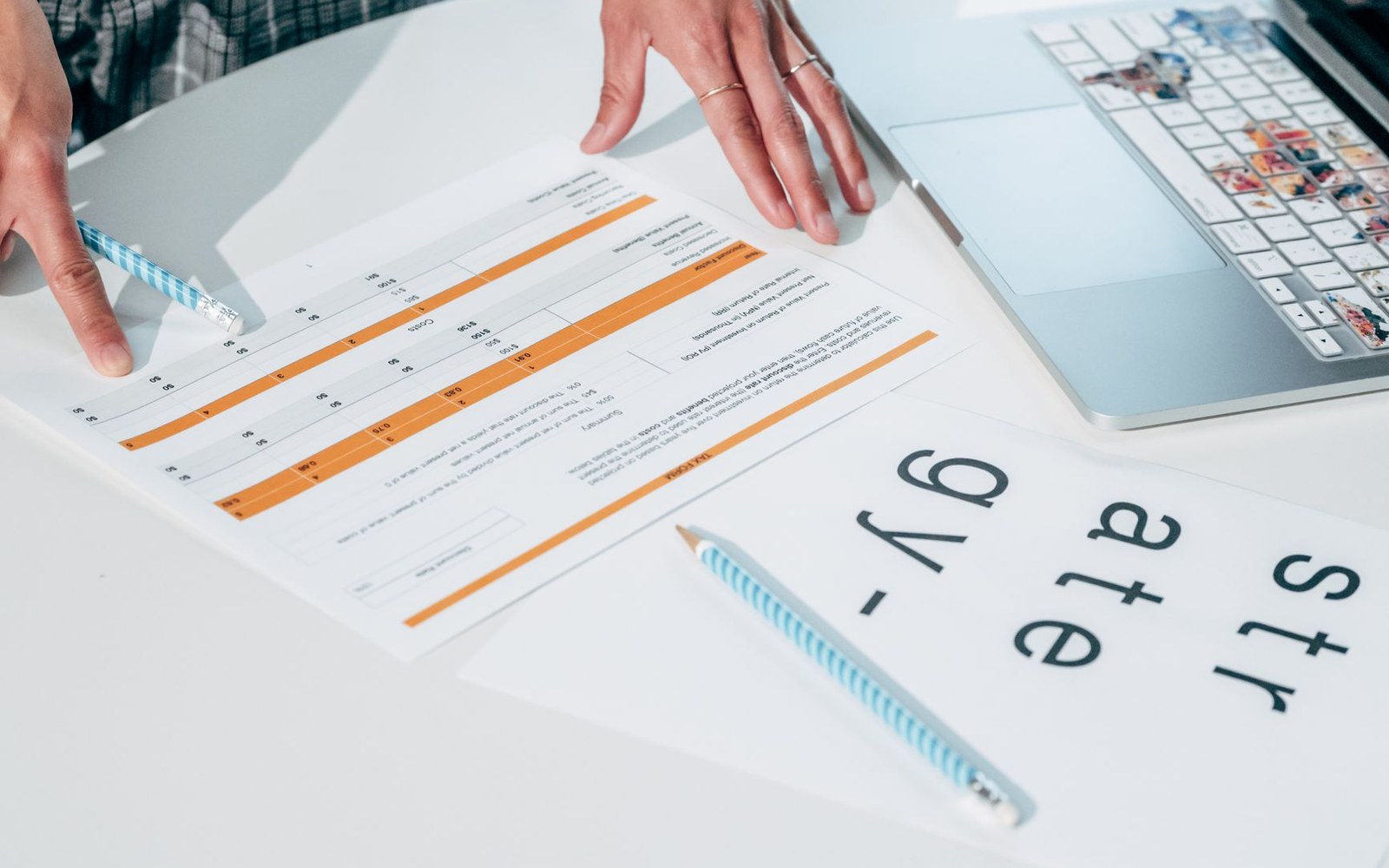 A printed Software Bill of Materials document on a desk beside a keyboard, the document's header and table structure legible, a pen resting across the top corner